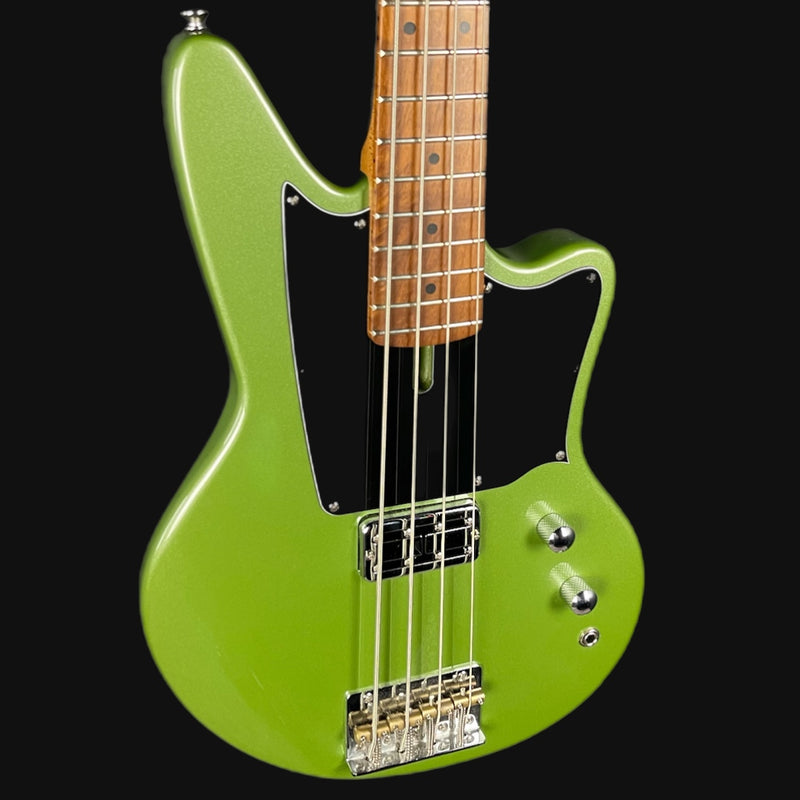 Green electric bass guitar with a black pickguard on a white background