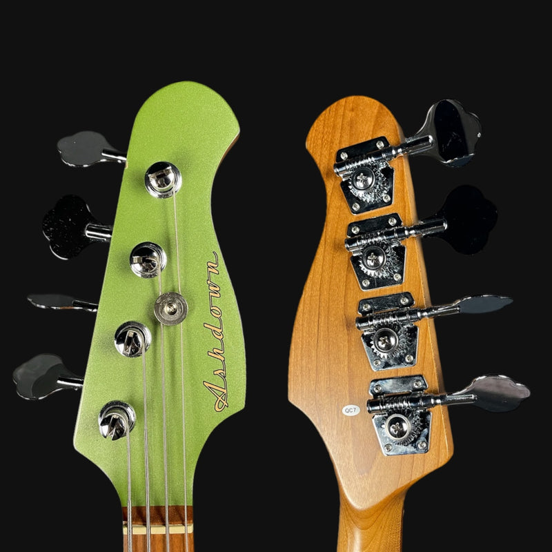 Close-up of green and brown guitar heads with 'Ashdown' branding on a black background