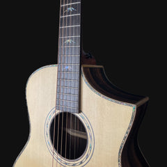 Close-up of an acoustic guitar with a black background
