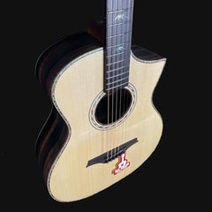 Acoustic guitar with a visible brand logo on a black background