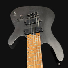 Electric guitar with a black body and wooden fretboard on a black background