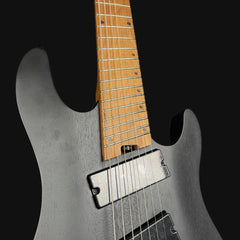 Close-up of a black electric guitar with a wooden fretboard on a black background
