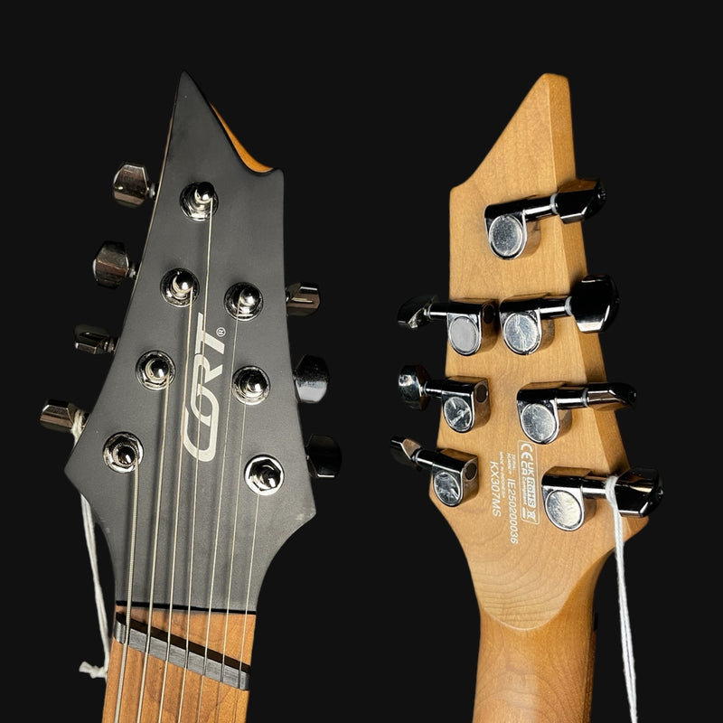 Close-up of two guitar heads with 'Gretsch' branding on a black background