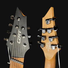 Close-up of two guitar heads with 'Gretsch' branding on a black background
