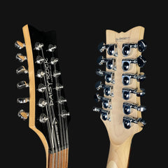 Two guitar heads with tuning pegs on a black background