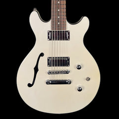 White electric guitar with a black pickguard on a black background