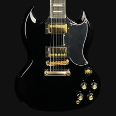 Black electric guitar with gold hardware on a black background