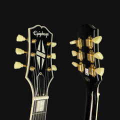 Close-up of two guitar heads with Epiphone branding on a black background
