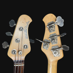 Close-up of two guitar heads with StewMac branding on a black background