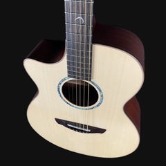 Acoustic guitar with a dark brown finish on a black background