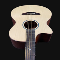 Acoustic guitar with a dark brown finish on a black background