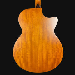 Back view of a wooden acoustic guitar on a black background
