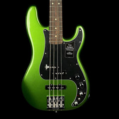 Green electric bass guitar on a black background