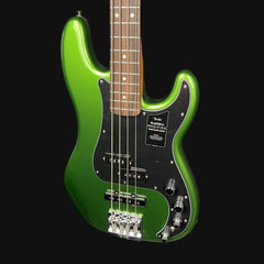 Green electric bass guitar on a black background