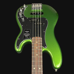 Green electric bass guitar with a black pickguard on a black background
