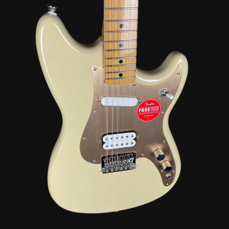 Beige electric guitar with a red Fender label on a black background