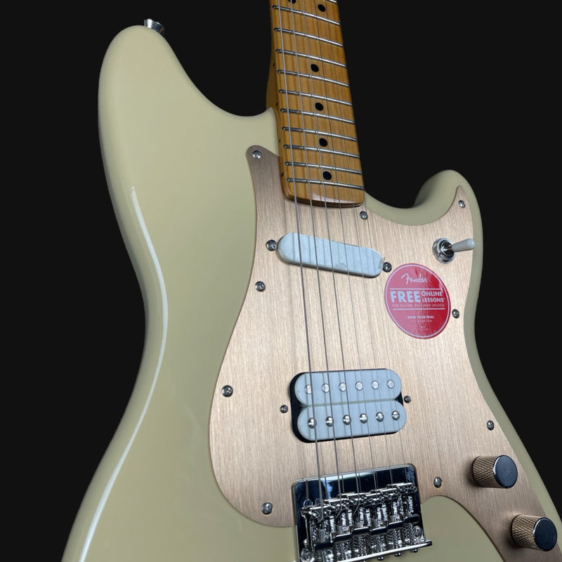 Electric guitar with a visible brand sticker on a black background