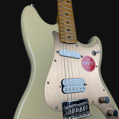 Electric guitar with a visible brand sticker on a black background