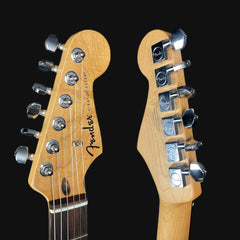 Close-up of Fender Stratocaster guitar heads on a black background