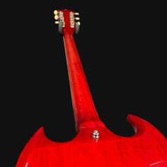 Red electric guitar headstock on a black background