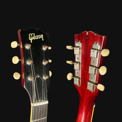 Gibson guitar heads in black and red on a black background