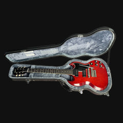 Red electric guitar in a gray case on a black background