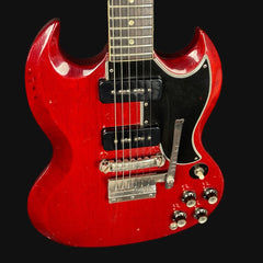 Red electric guitar on a black background