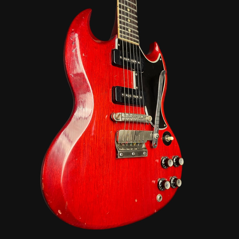 Red electric guitar on a black background