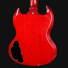 Red electric guitar body on a black background