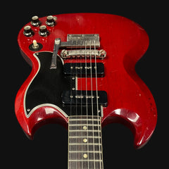 Red electric guitar on a black background