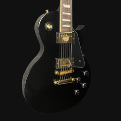 Black electric guitar with gold hardware on a black background