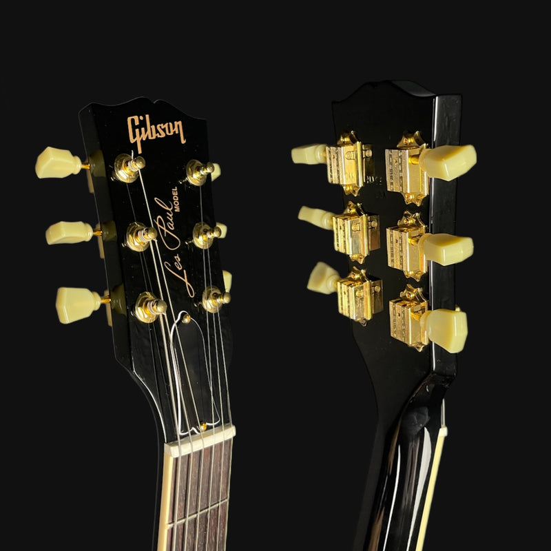Gibson Les Paul guitar heads with tuning pegs on a black background