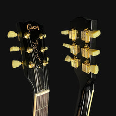Gibson Les Paul guitar heads with tuning pegs on a black background
