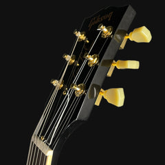 Gibson guitar headstock with tuning pegs on a black background