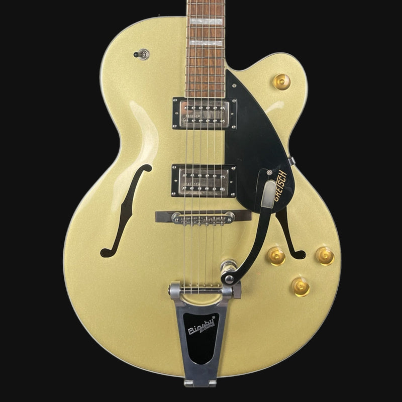 Electric guitar with a cream finish and black pickguard on a black background