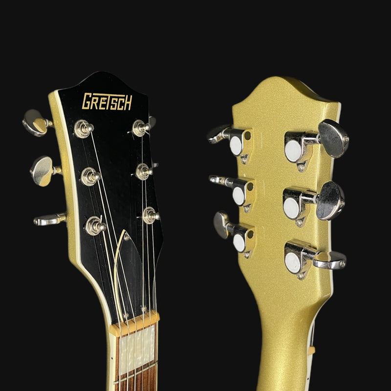 Close-up of two guitar heads with 'Gretsch' branding on a black background