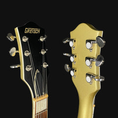 Close-up of two guitar heads with 'Gretsch' branding on a black background