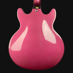 Pink electric guitar body on a black background