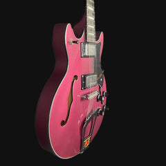 Pink electric guitar on a black background