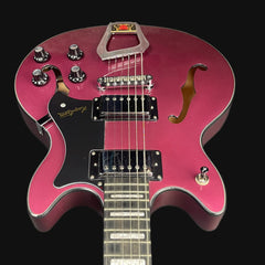 Pink electric guitar with a black pickguard on a black background