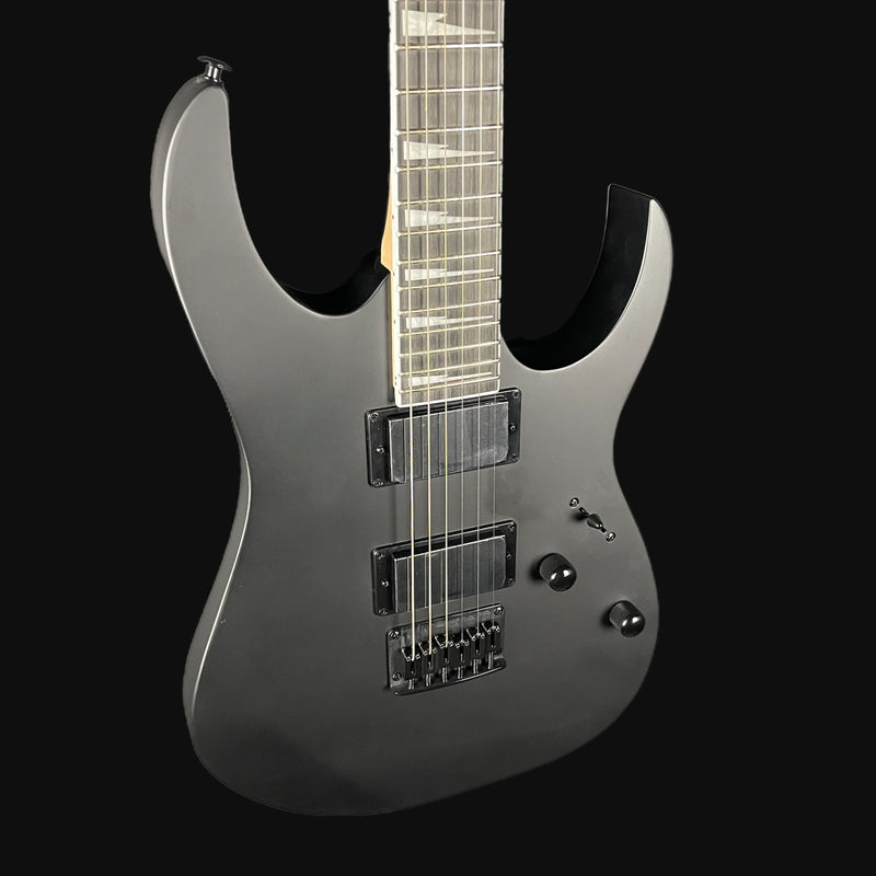 Silver electric guitar on a black background