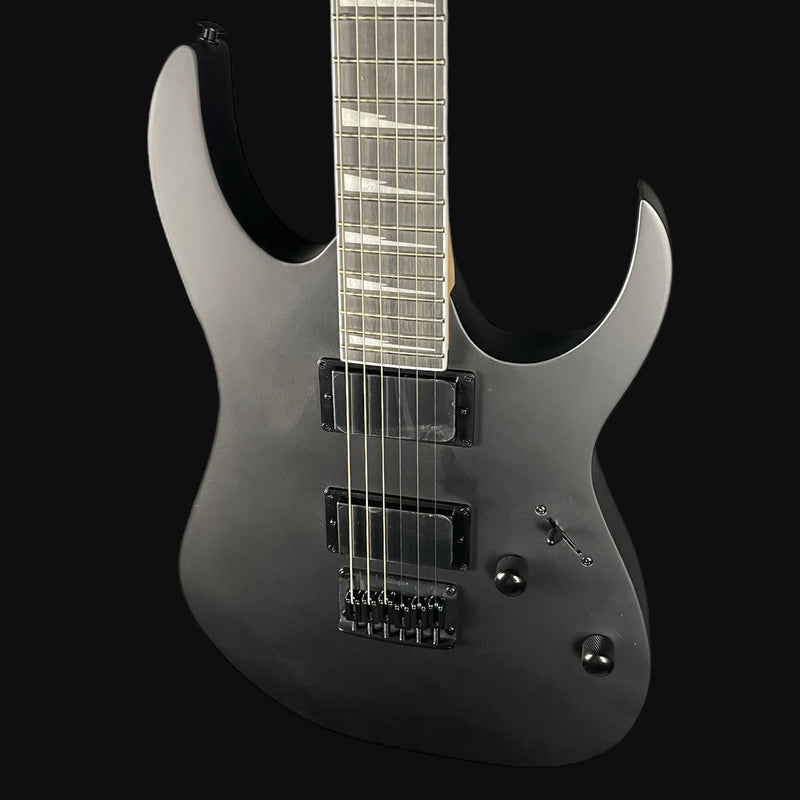 Black electric guitar on a black background