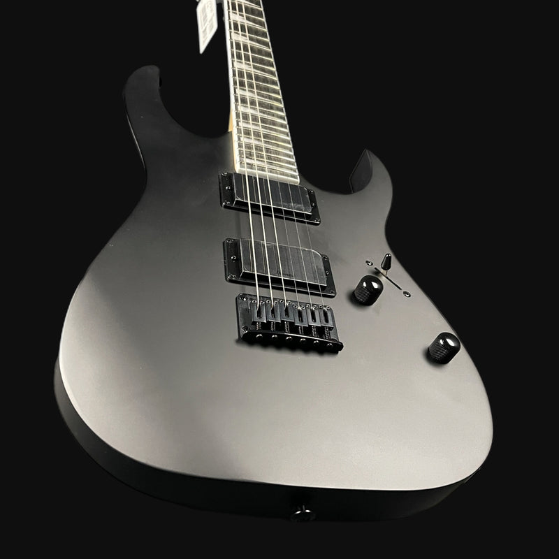 Silver electric guitar on a black background