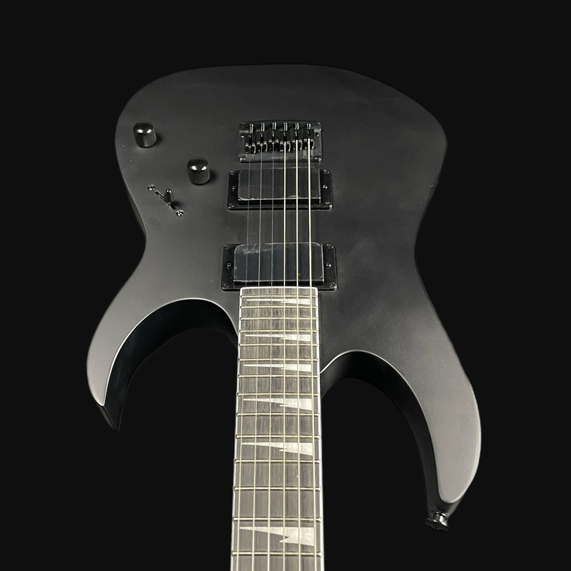 Black electric guitar on a black background