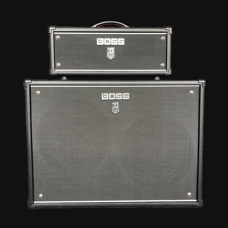 Two Boss guitar amplifier cabinets stacked on a black background