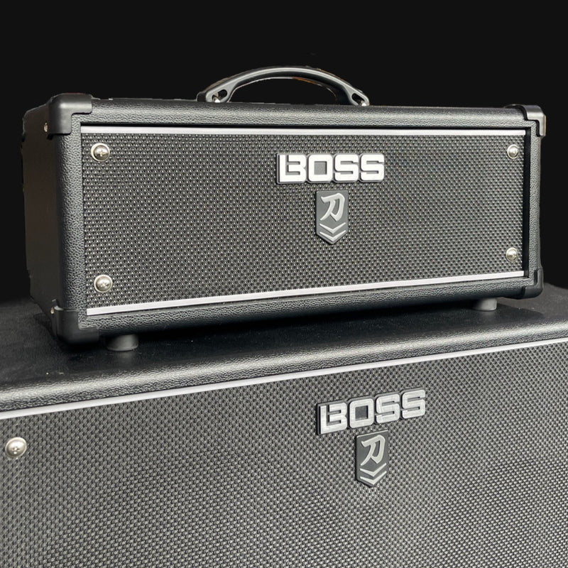 Boss guitar amplifier head and cabinet on a black background