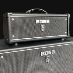 Boss guitar amplifier head and cabinet on a black background