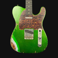 Green electric guitar with a worn finish on a black background
