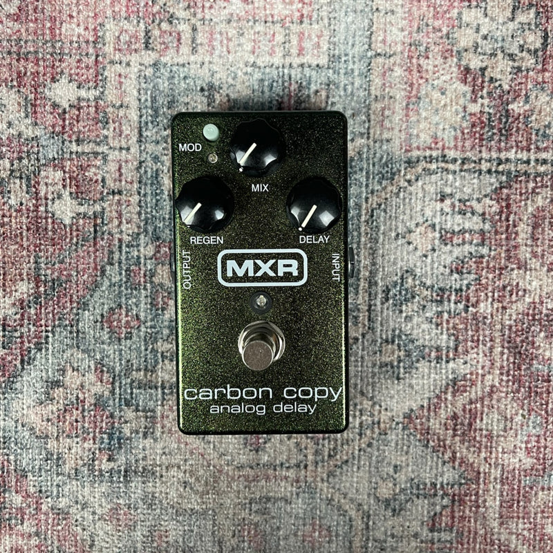 MXR carbon copy analog delay pedal on a patterned surface