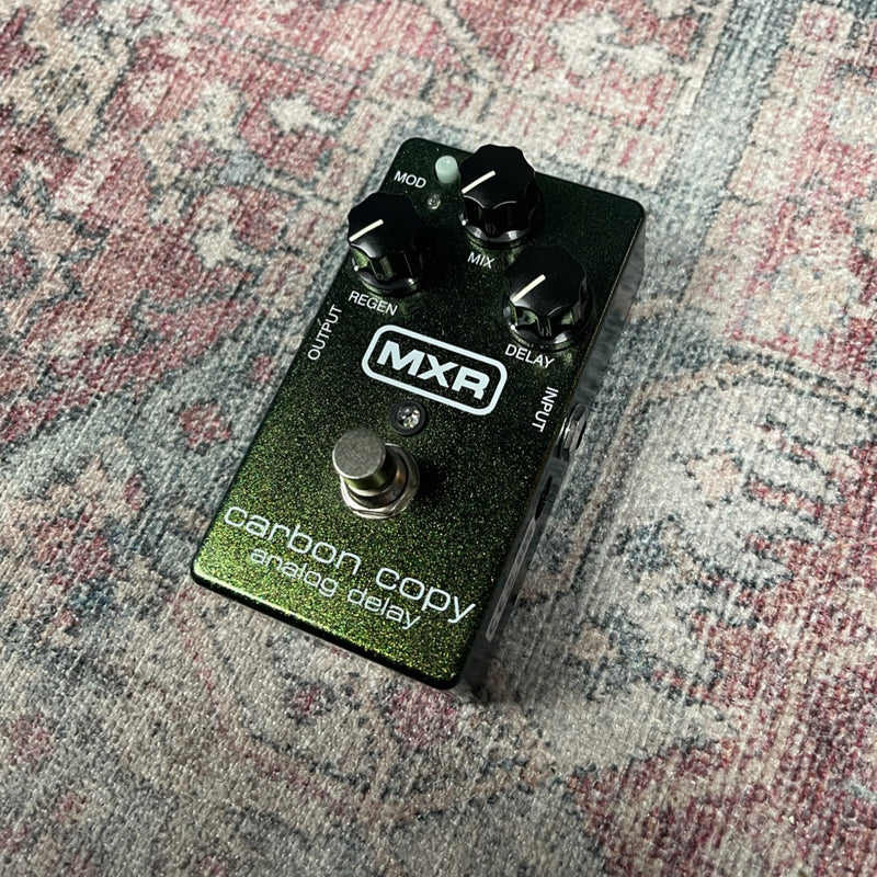 MXR carbon copy analog delay guitar effects pedal on a patterned surface